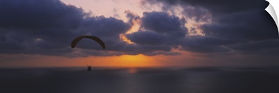 Silhouette of a person paragliding over the sea, Blacks Beach, San Diego, California
