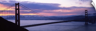Silhouette of a suspension bridge at dusk, Golden Gate Bridge, San Francisco, California,