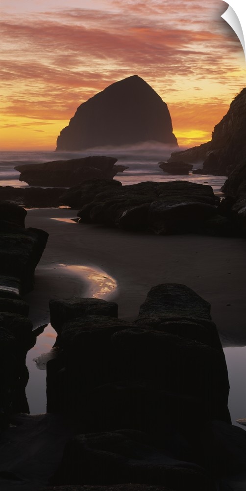 Silhouette of rock formations on the beach, Haystack Rock, Cape Kiwanda State Park, Pacific City, Oregon