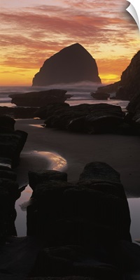 Silhouette of rock formations on the beach, Haystack Rock, Cape Kiwanda State Park, Pacific City, Oregon