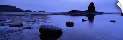 Silhouette of rocks on the beach, Black Nab, Whitby, England