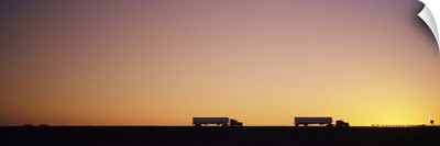 Silhouette of two trucks moving on a highway, Interstate 5, California