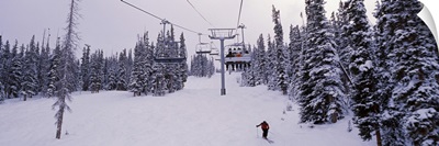 Ski lift passing over a snow covered landscape, Keystone Resort, Keystone, Summit County, Colorado