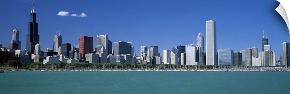Panoramic photograph shows a row of skyscrapers in the Midwestern United States overlooking the calm waters of a river on ...