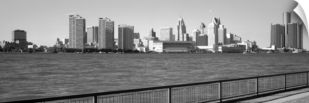 This panoramic photograph is in black and white and taken of the Detroit skyline from across the river that is in front of...