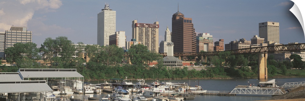 A panoramic view of the Memphis, Tennessee skyline, including boats on the river.