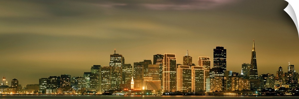 Large panoramic image of the San Francisco skyline lit up at dusk.