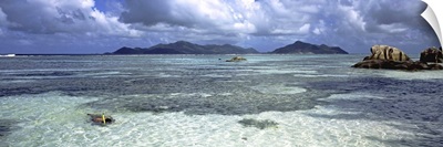 Snorkeler in the waters of Anse Source d'Argent beach, La Digue Island, Seychelles
