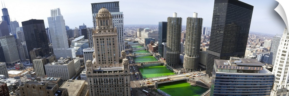 The water of the Chicago River has been dyed green in celebration of Saint Patrick's day. It appears strange as it flows t...