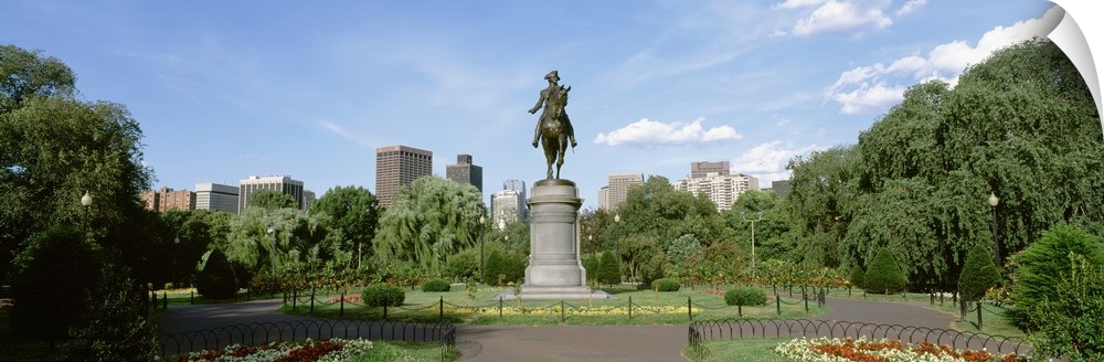 Statue of a man riding a horse in the middle of well kept city park in Boston, Massachusetts.