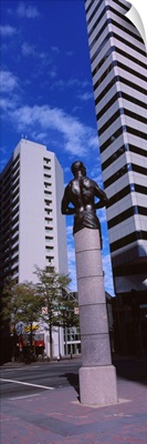 Statue in front of buildings in a city, Charlotte, North Carolina