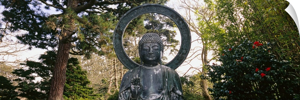 This Buddha statue is pictured as a panorama with trees scattered about in the background.