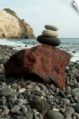 Stone balancing on a rock at the coast, Akrotiri, Santorini, Cyclades Islands, Greece
