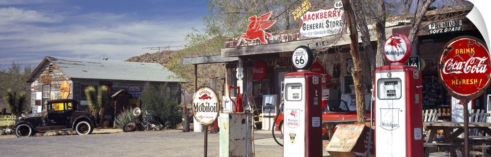 Long panoramic photo on canvas of a vintage Route 66 gas station with an old car outside.