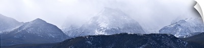 Storm clouds over snow covered mountains, Rocky Mountain National Park, Colorado,