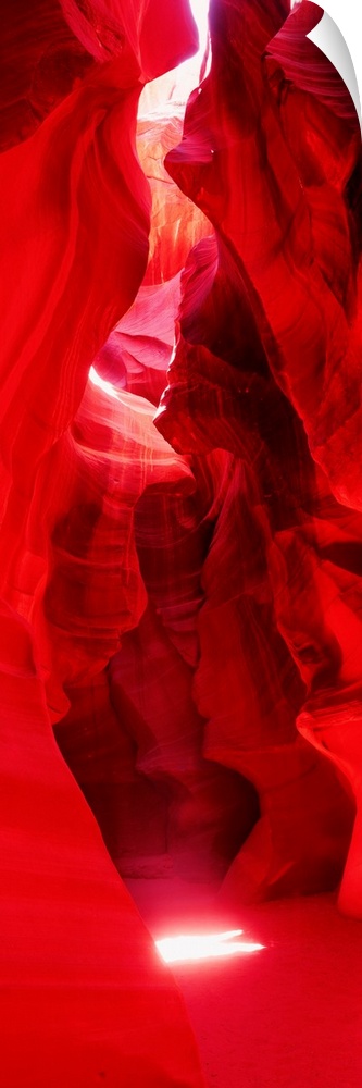 A vertical photograph with vivid colors shows the passage through a narrow canyon.