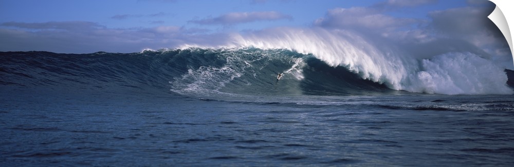 Panoramic photo of a big wave crashing in the Pacific Ocean.