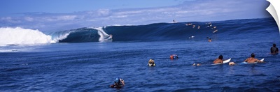 Surfers in the sea, Tahiti, French Polynesia