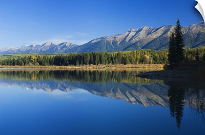Swan Mountain Range reflecting in calm water of Rainy Lake, Seeley Swan Valley, Montana