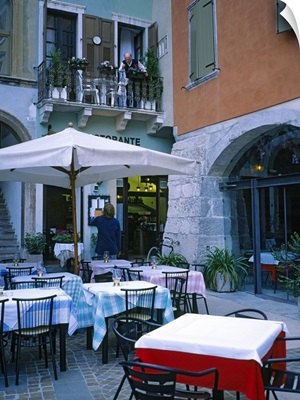 Tables and chairs at a sidewalk cafe, Lake Garda, Italy
