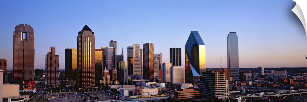 Oversized, panoramic photograph of the Dallas skyline at sunrise.