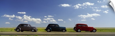 Three Hot Rods moving on a highway, Route 66,