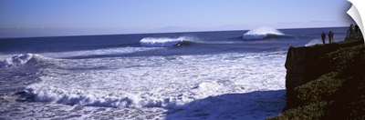Tourist looking at waves in the sea, Santa Cruz, Santa Cruz County, California,