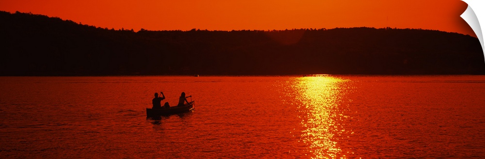 Tourists canoeing in a lake at sunset, Oquaga Lake, Deposit, Broome County, New York State