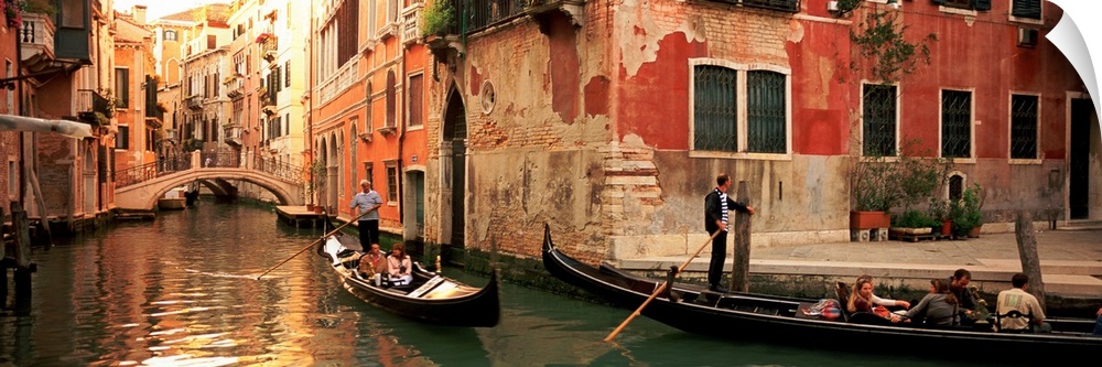 Gondolas paddling through canals lined with historic Venetian buildings.