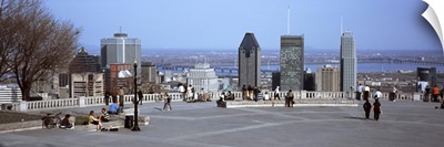 Tourists on a mountain lookout with a city in the background, Kondiaronk Belvedere, Montreal, Quebec, Canada