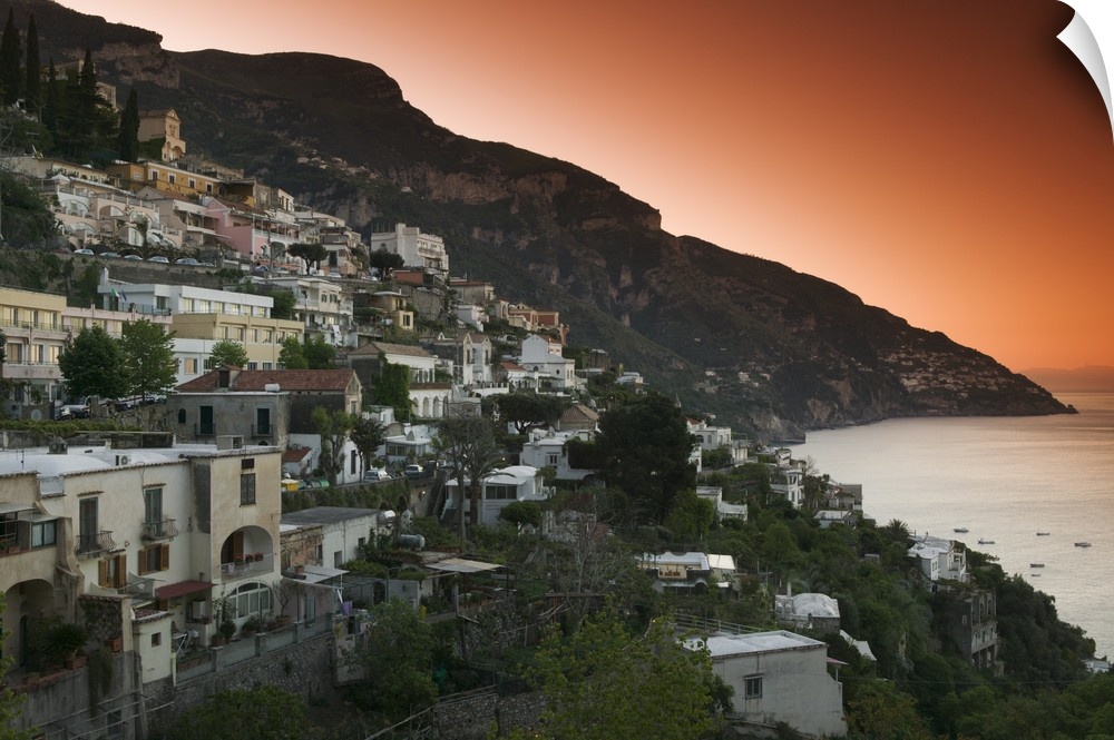 Oversized, landscape photograph of several cities in Italy on a hillside at dusk, including Positano, Salerno and Campania.