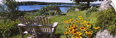 Two adirondack chairs in a garden, Peaks Island, Casco Bay, Maine