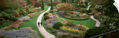 Two people walking in garden, Butchart Gardens, Brentwood Bay, Vancouver Island, British Columbia, Canada