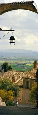Umbrian countryside viewed through an alleyway, Assisi, Perugia Province, Umbria, Italy