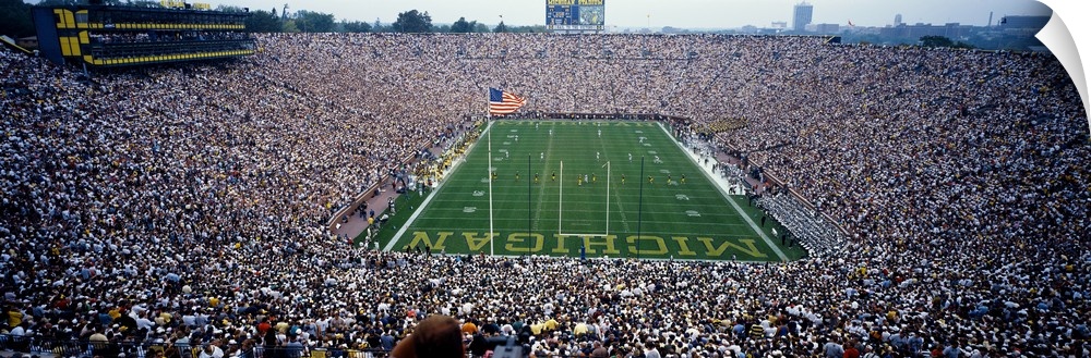 Wide angle, aerial photograph of Michigan Stadium full of fans, during a University of Michigan football game in Ann Arbor.