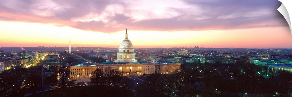 A high angle photograph of the Capital Building and National Mall illuminated in the evening light.