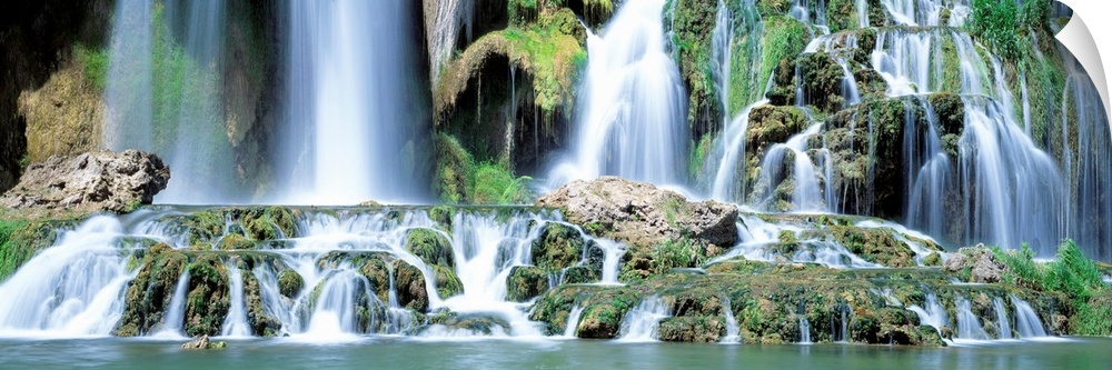 Serene wall art for the home or office a panoramic photograph of the bottom of a rocky waterfall with multiple cascades.