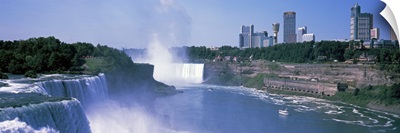 Waterfall with city skyline in the background, Niagara Falls, Ontario, Canada