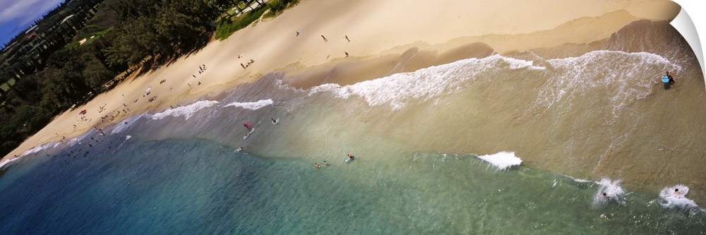 Long photo on canvas of ocean waves crashing on the shore of a Hawaiian beach.