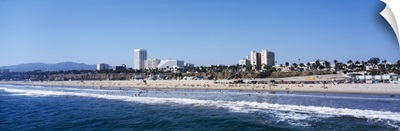 Waves on the beach with buildings in the background, Santa Monica Beach, Santa Monica, California