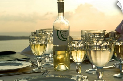 Wine glasses with a wine bottle on a table, Santorini, Cyclades Islands, Greece