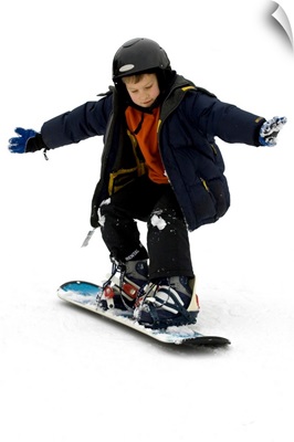 9 year old boy riding his snowboard
