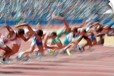 Blurred action at the start of a mens 100 meter track and field race