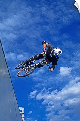 BMX cyclist flies over the vert