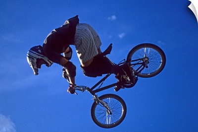 BMX cyclist flies over the vert