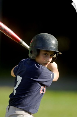Boy batting during baseball game
