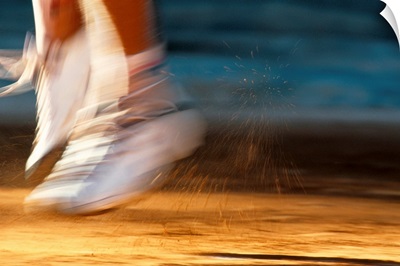 Detail of blurred action of tennis players feet during a serve