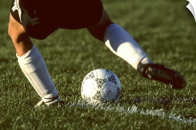 Detail of foot about to kick a soccer ball