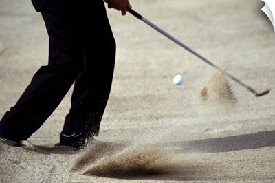 Detail of golfer blasting out of sand trap