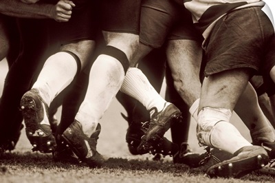 Detail of the feet of a group of ruby players in a scrum